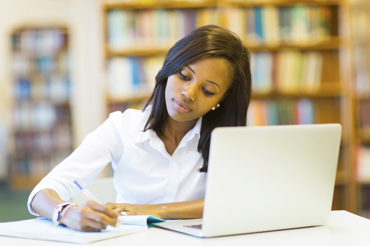 college student studying at computer