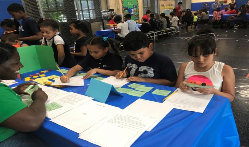 Manhattan College MBK Grant recipient Courtney Weaver engages students at Family Math Night mentor