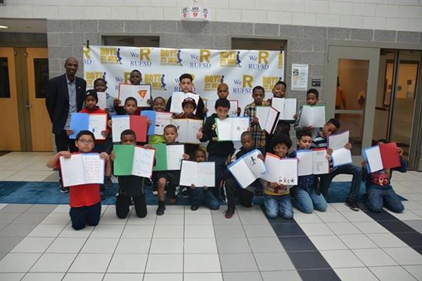Real Men Read Kick-off event: Patrick Oliver, author and keynote speaker, worked with the young men in the Boys to Men program to create a vision board based on his book, On My Own: Vision Board Guidebook for Young People