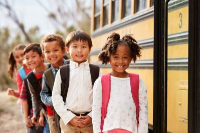 Elementary school students at school bus