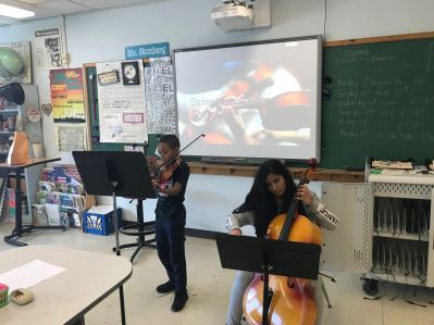 Student presenting for Genius Hour about string instruments.