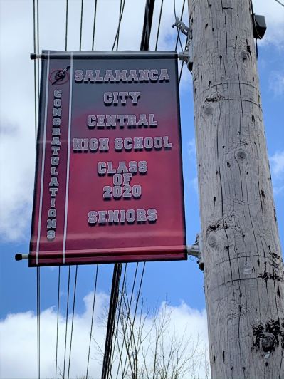 Banner celebrating Class of 2020 students hands from a utility pole