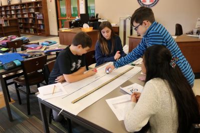 Four students work as a team on their meter-long track.