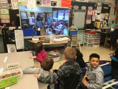 Students connecting with another classroom through video-conferencing