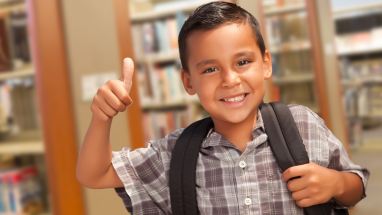student in library with backpack