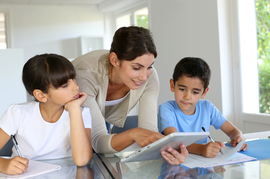 Teacher instructing students on a tablet