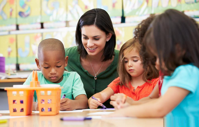 Photo of teacher working with students