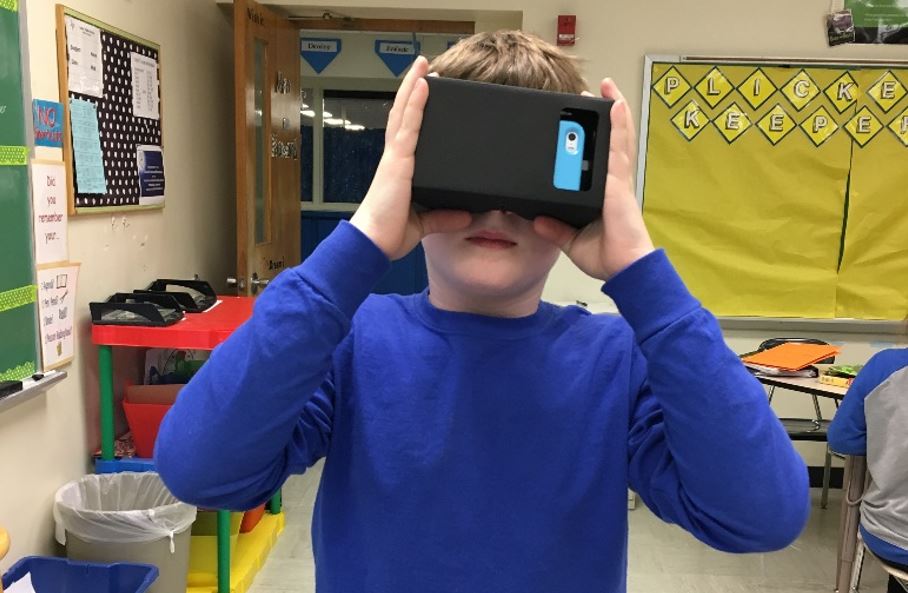 A student using his phone to experience virtual reality.