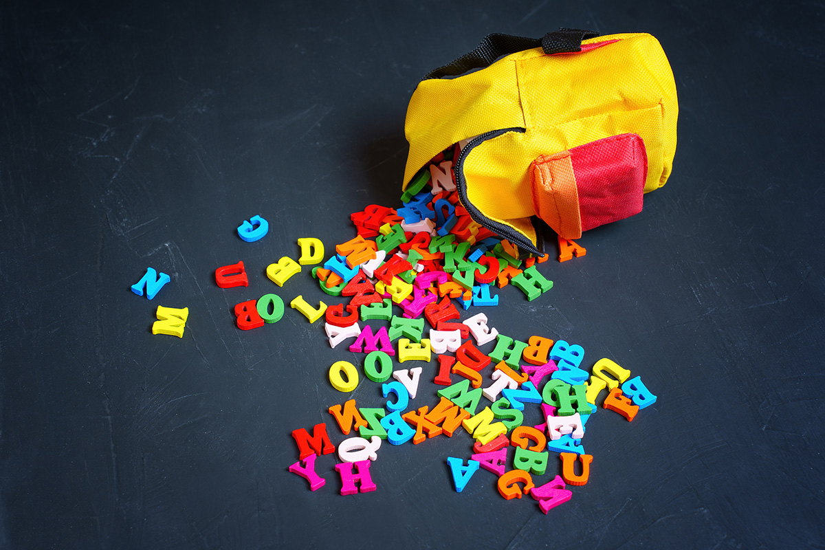 Backpack with letters spilling out.