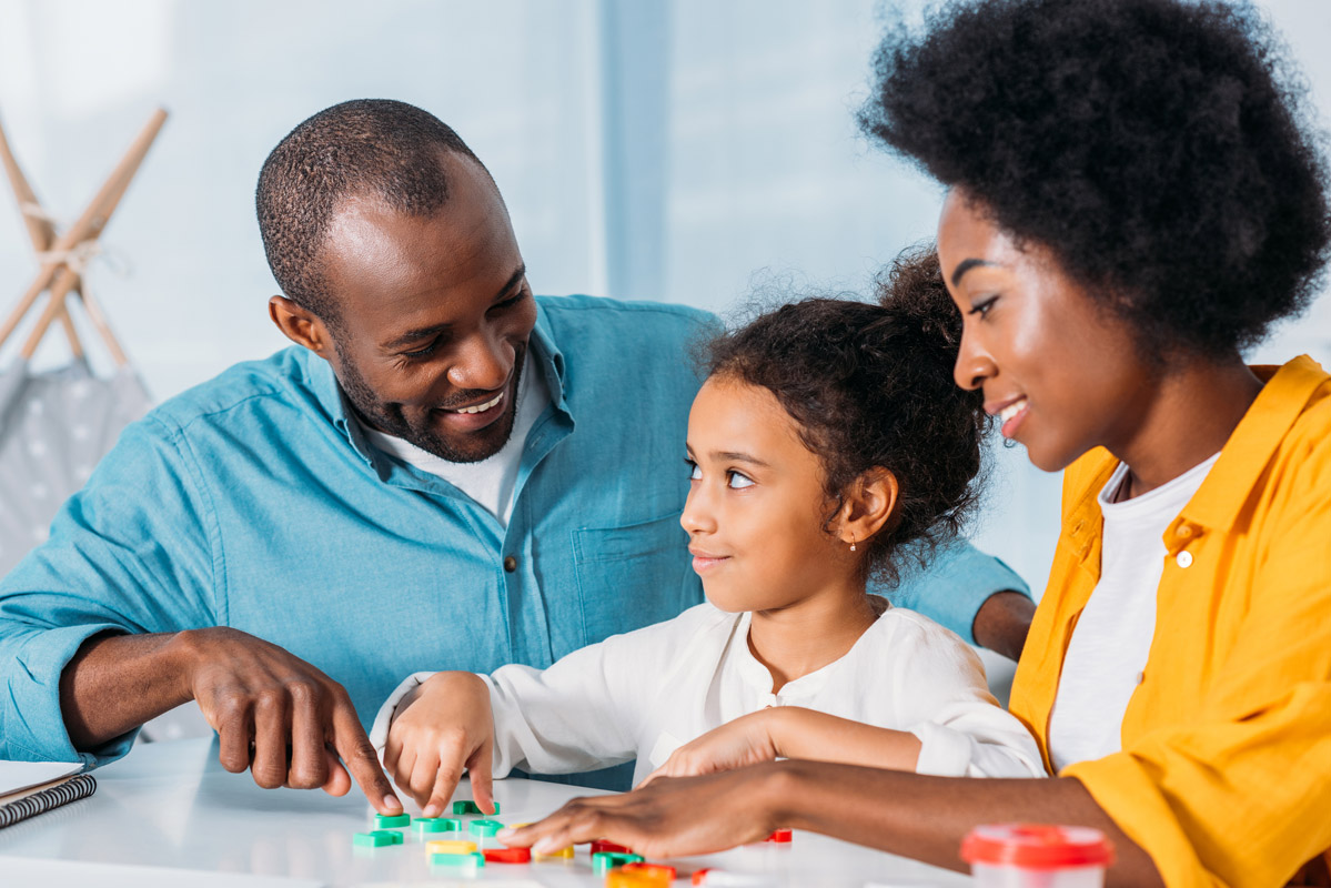 parents helping a child learn