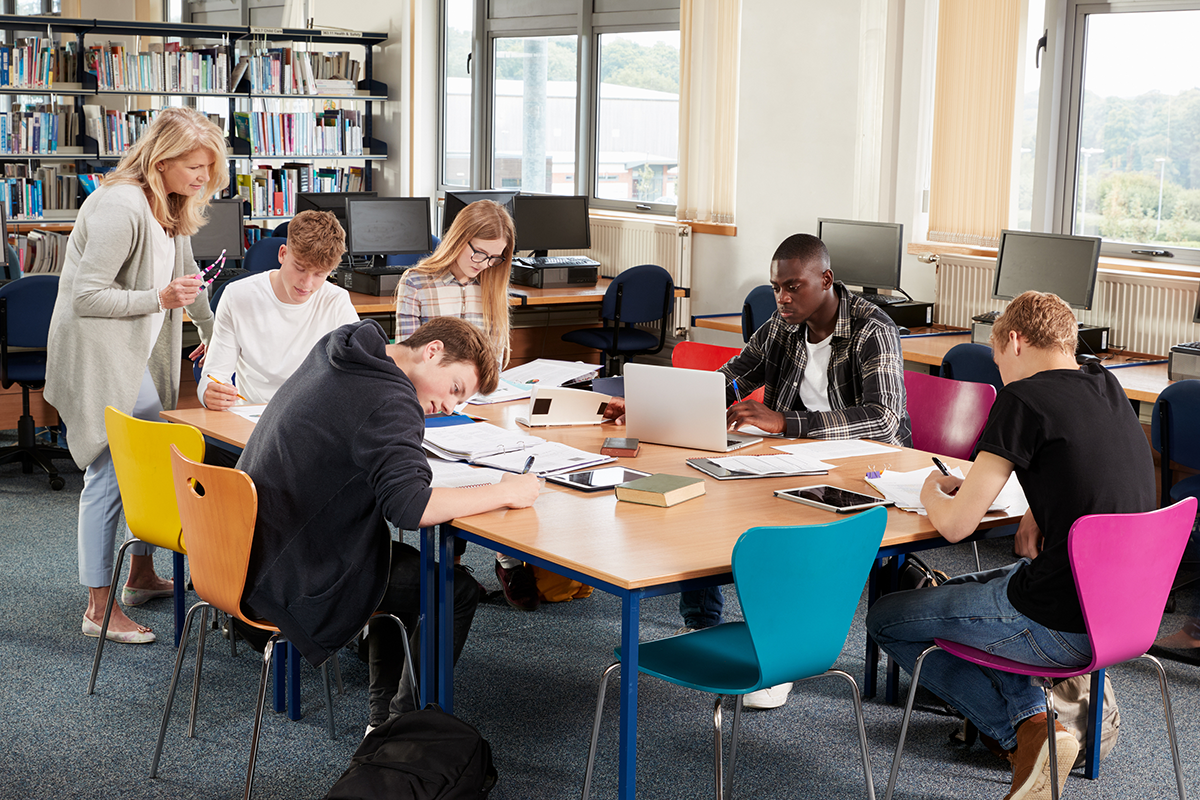 Group of students in library with teacher