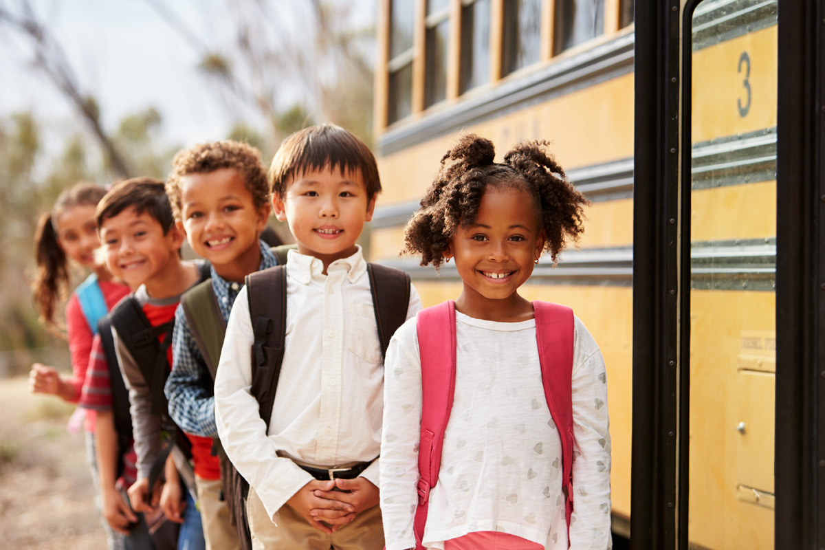 Elementary school students at school bus