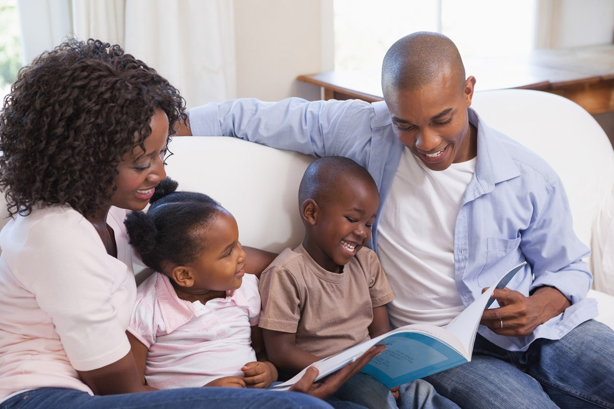 Parents reading book to children