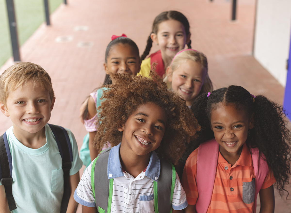 Group of happy elementary students smiling