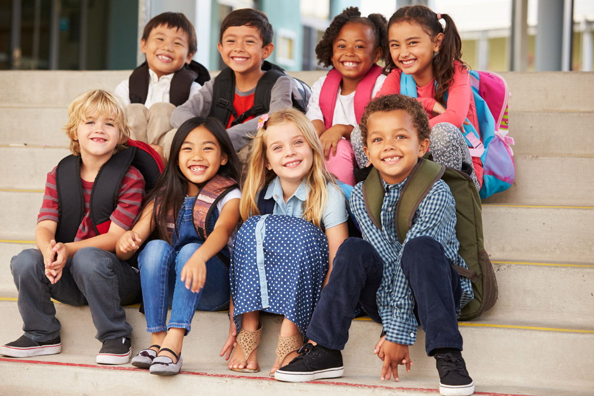 Group of elementary students sitting on stairs