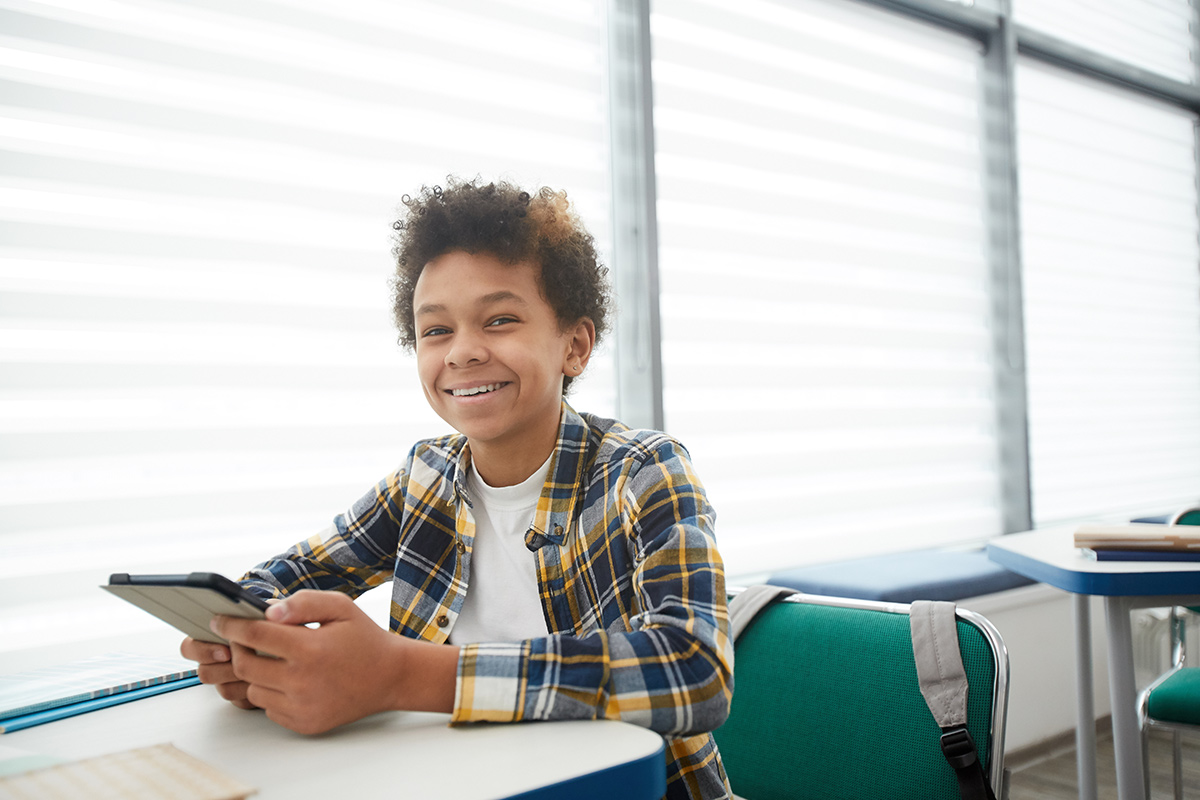 Student at desk with tablet