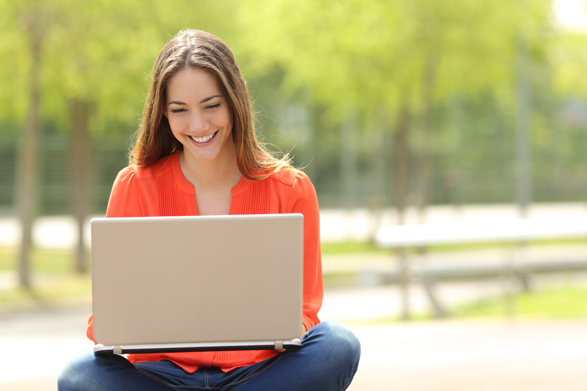 Student working outside on a laptop