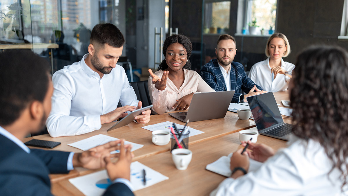 People meeting and working at a conference table.