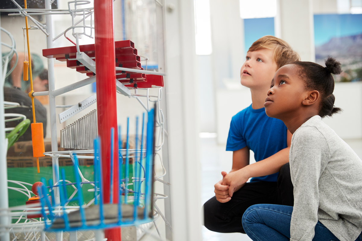 Two Kids Kneeling and Looking