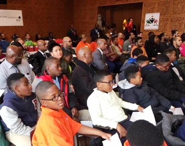 Young men listen to distinguished guest speakers at the Boys Who Read, Lead! Initiative launch event Brooklyn meeting