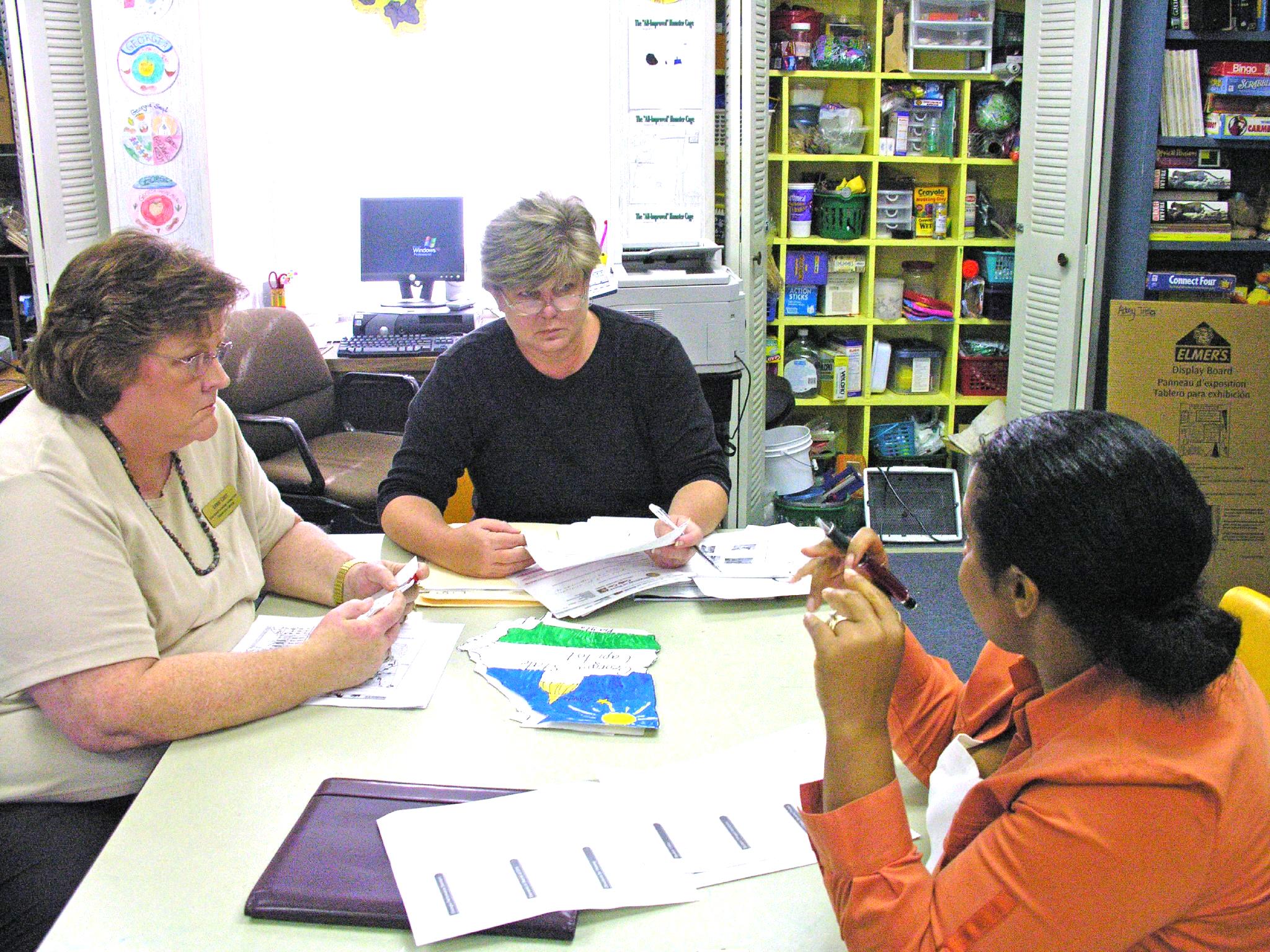 Teachers and technology specialists meeting to discuss plans for documenting students completing school projects that teach the standards using best practices.