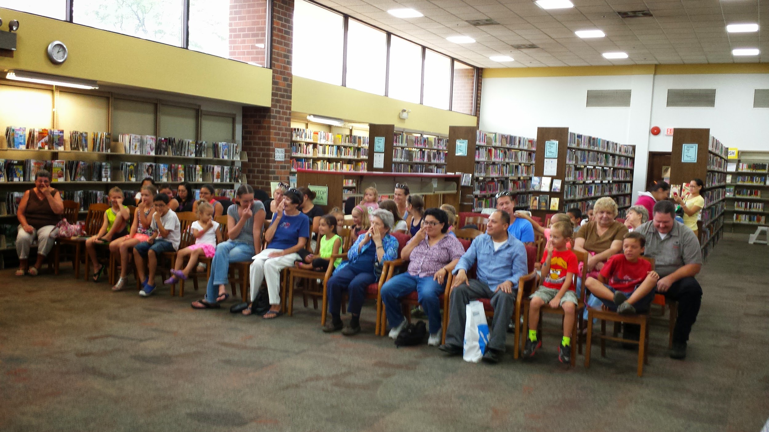 Audience at an event in a library.