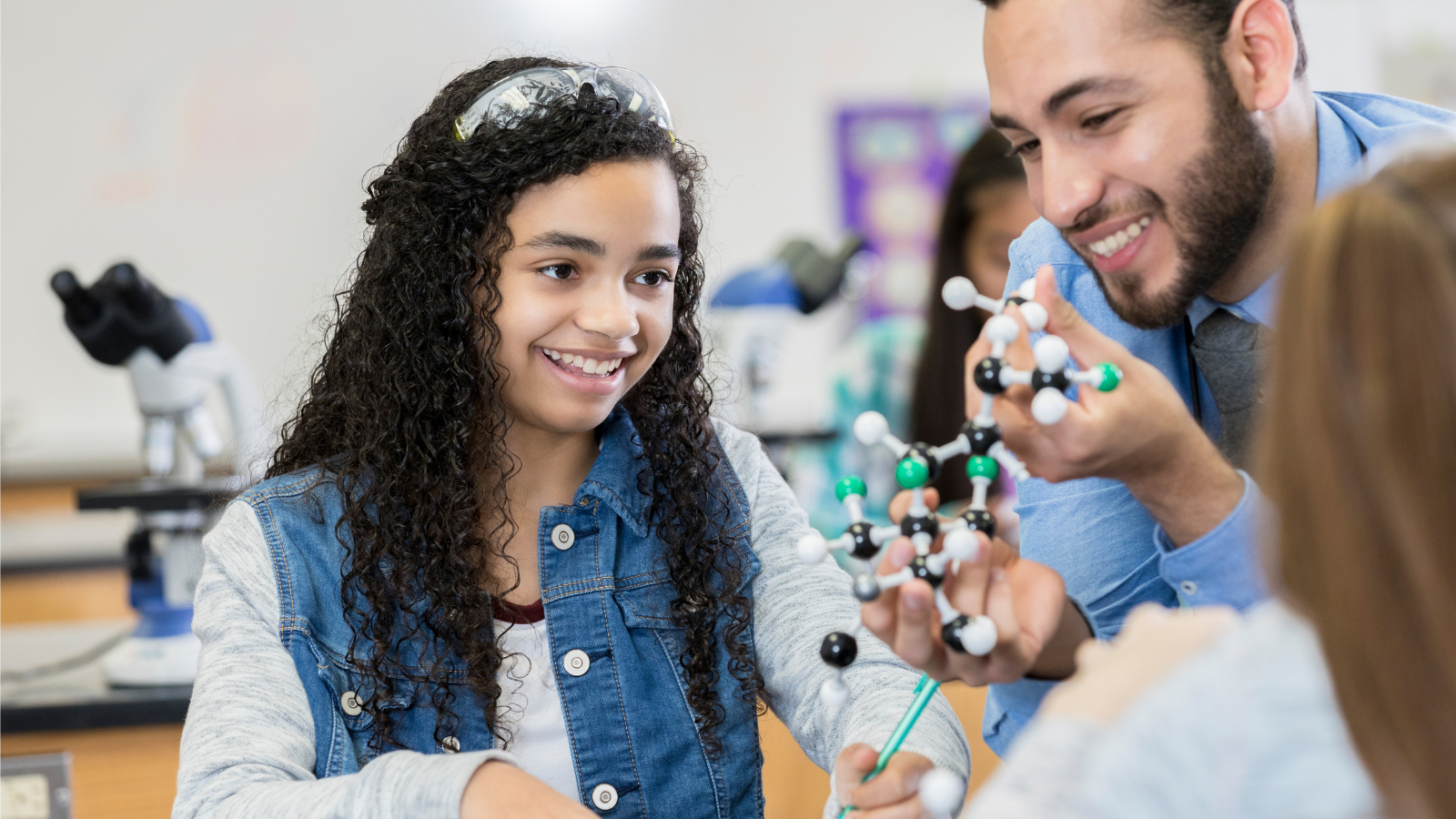 science teacher with student in classroom