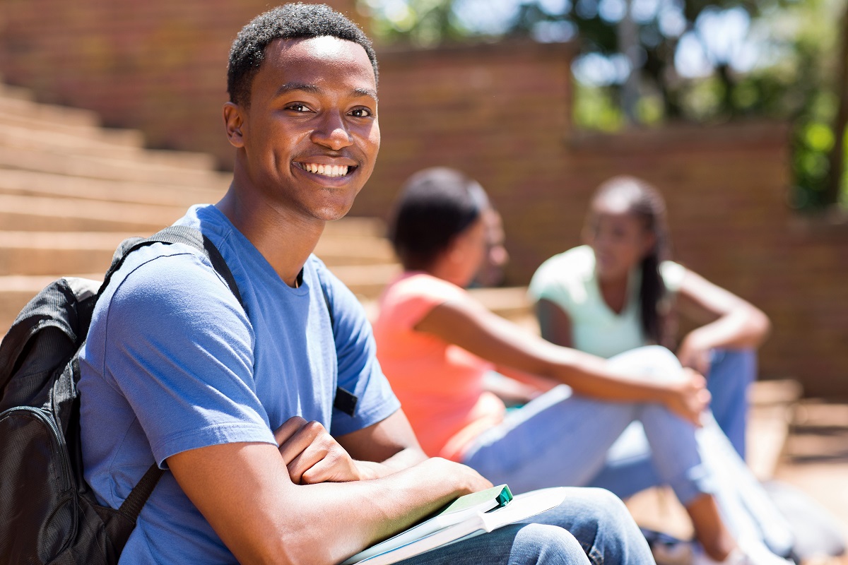 happy student sitting on steps