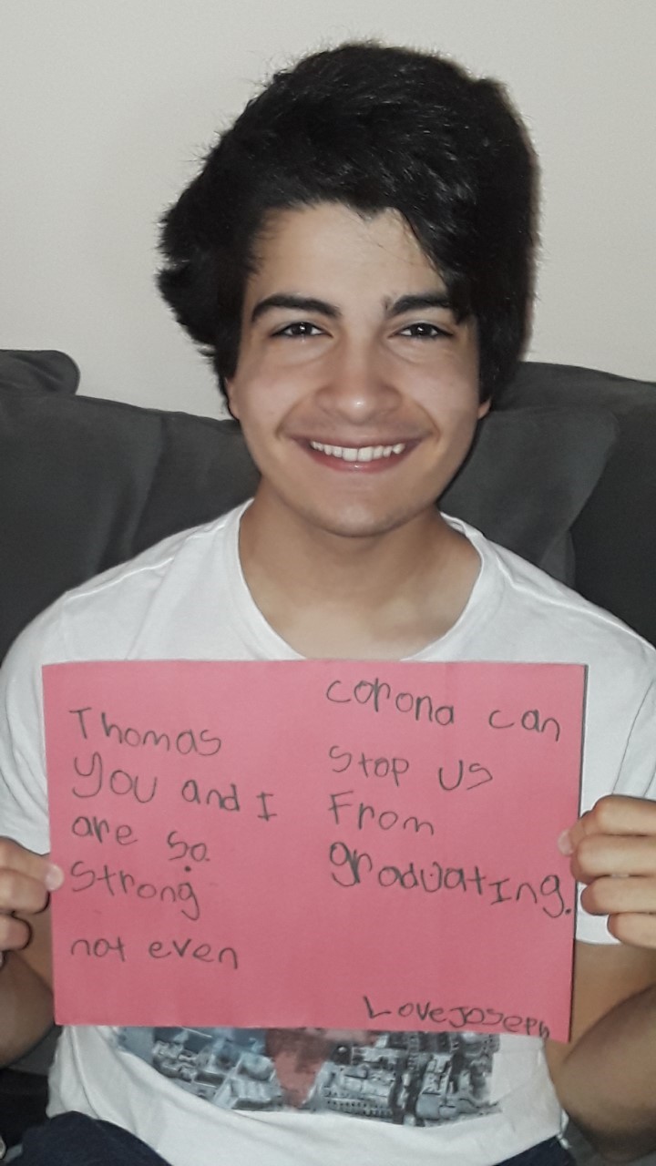 Graduating senior with card from kindergartner