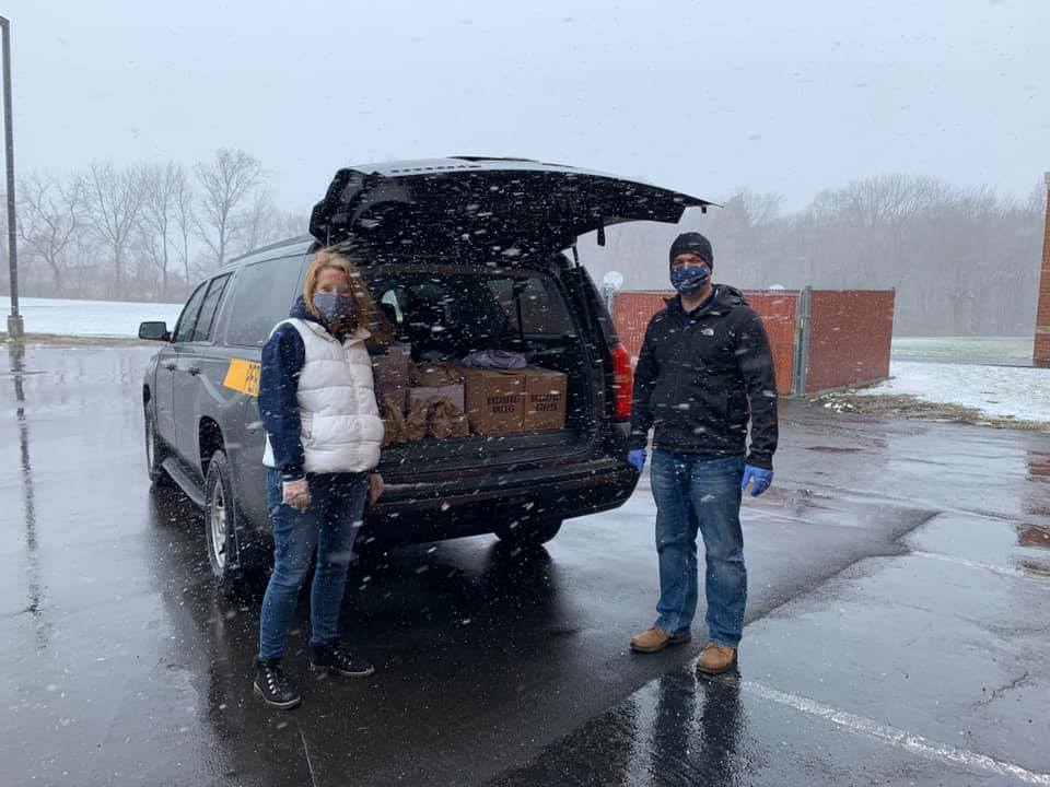 District staff packing school van with lunches for families.