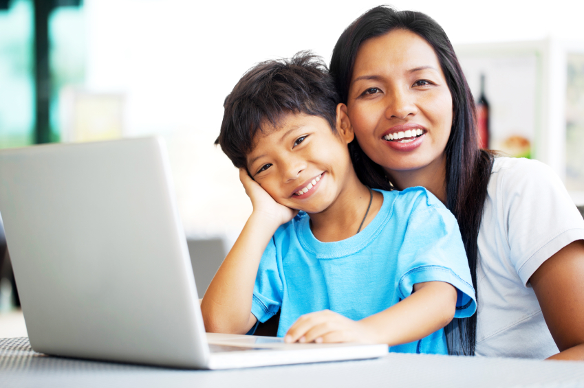 happy parent and child at a computer