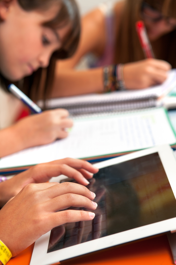 Middle school students working on tablet