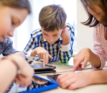 elementary children working on tablets