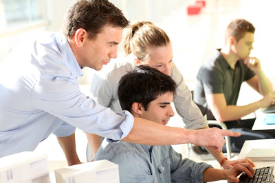 Students collaborating at a computer.