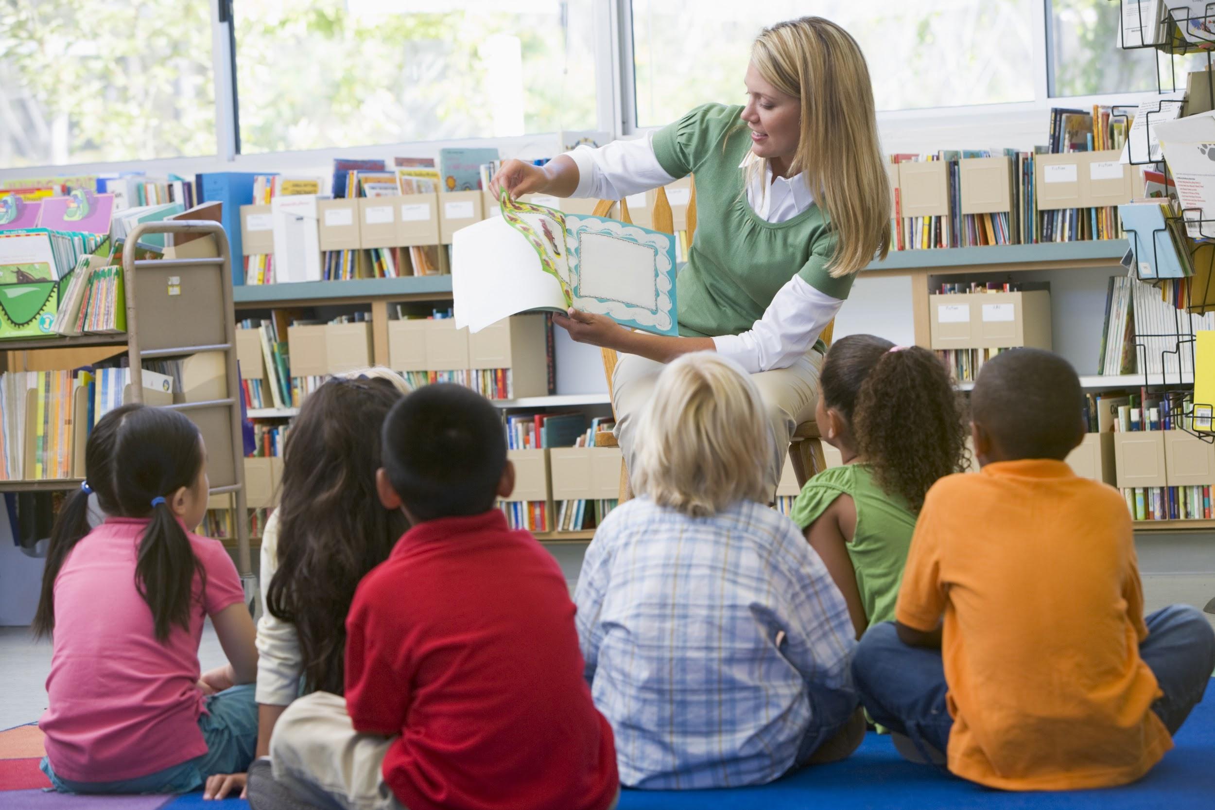 Teacher reading to young students