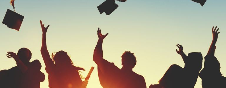 graduates throwing caps in the air