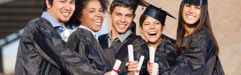 Graduates in a line holding diplomas