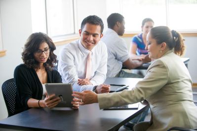 School administrators looking at tablet