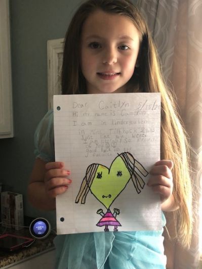 Kindergarten student with note for a graduating senior