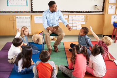 Teacher with group of elementary students in circle