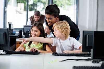 Teacher helping students in classroom