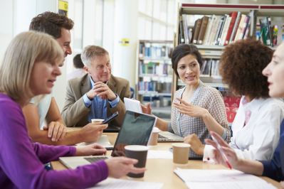 teachers sitting at a table talking