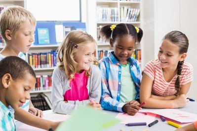 Image of students interacting with each other in a classroom setting.