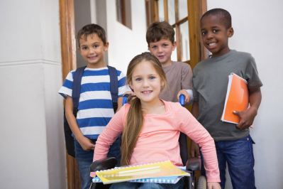 Students raising hands in classroom