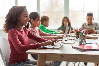 Girl using laptop in classroom