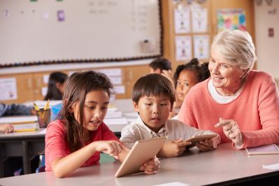 Teacher with students using tablet