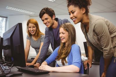 Students gathered around a computer