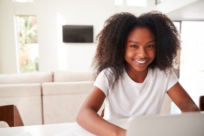 Smiling teenage girl with a computer