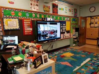 Students videoconferencing with another classroom in school