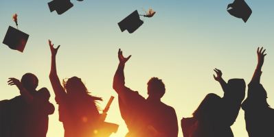 graduates throwing caps in the air